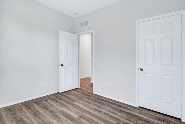 unfurnished bedroom with hardwood / wood-style flooring