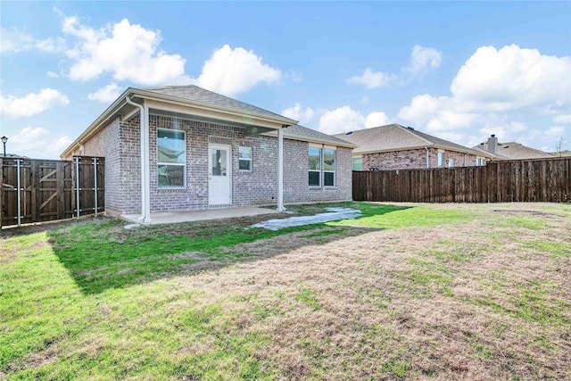 back of property featuring a yard and a patio