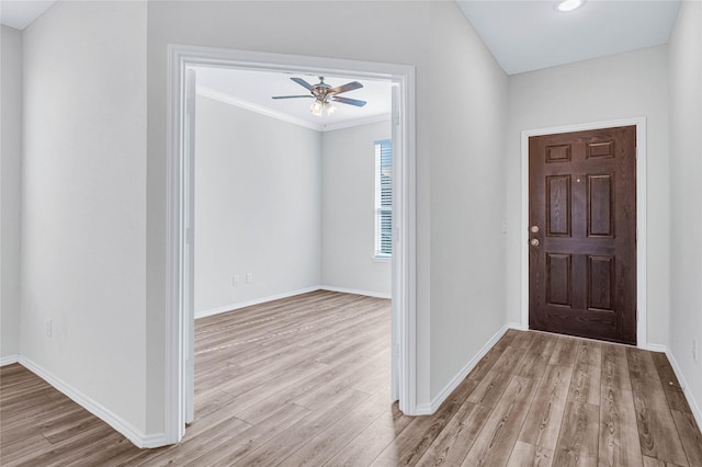 entryway featuring ceiling fan, crown molding, and light hardwood / wood-style floors