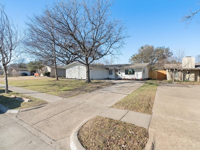 single story home featuring a garage and a front yard