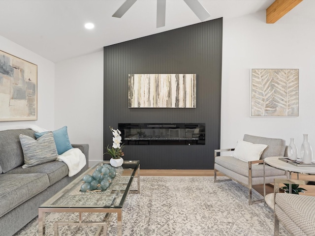 living room featuring light wood-type flooring, ceiling fan, and vaulted ceiling with beams