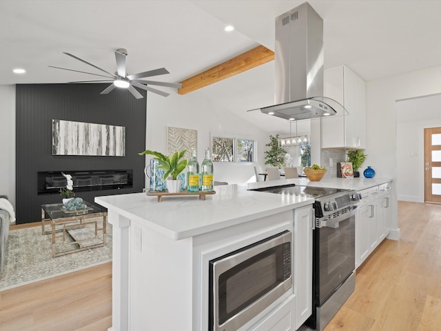 kitchen featuring stainless steel appliances, decorative backsplash, island range hood, and white cabinets