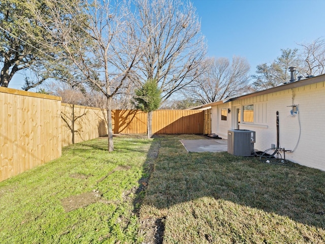 view of yard featuring central air condition unit and a patio