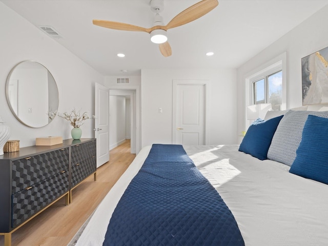 bedroom with ceiling fan and light hardwood / wood-style floors