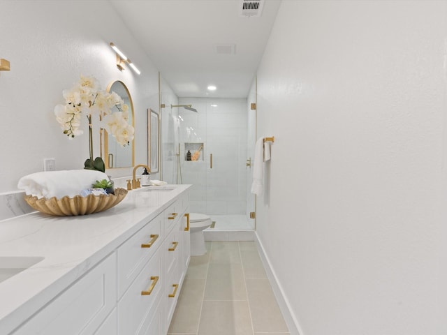 bathroom featuring toilet, tile patterned floors, an enclosed shower, and vanity