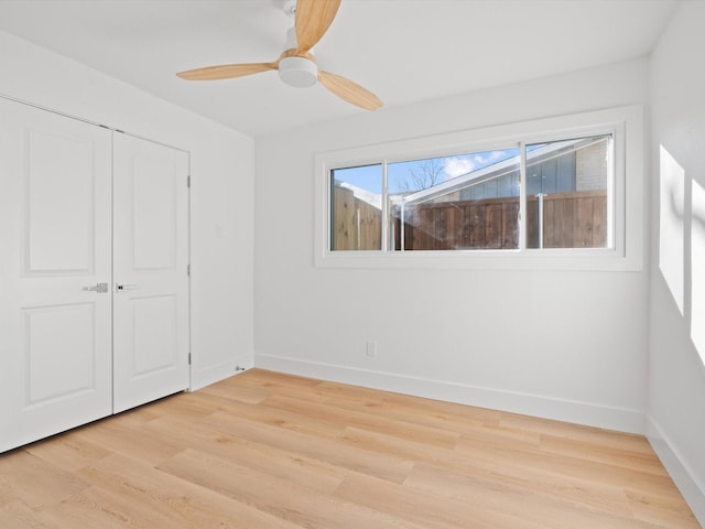 unfurnished bedroom with ceiling fan, a closet, and light hardwood / wood-style flooring