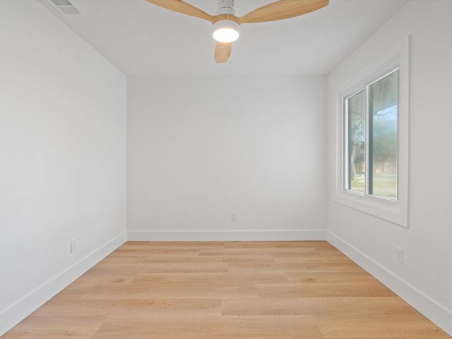 empty room with ceiling fan and light hardwood / wood-style floors