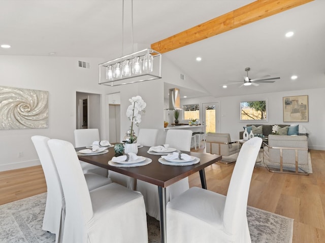 dining room with ceiling fan, light hardwood / wood-style flooring, and lofted ceiling with beams