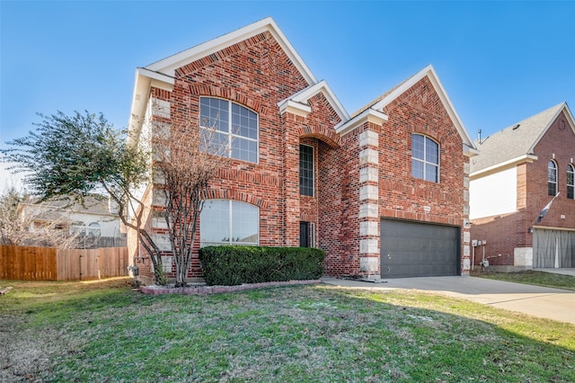 view of property featuring a front yard and a garage