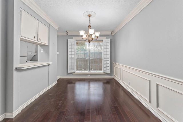 unfurnished dining area featuring a notable chandelier, a textured ceiling, and ornamental molding