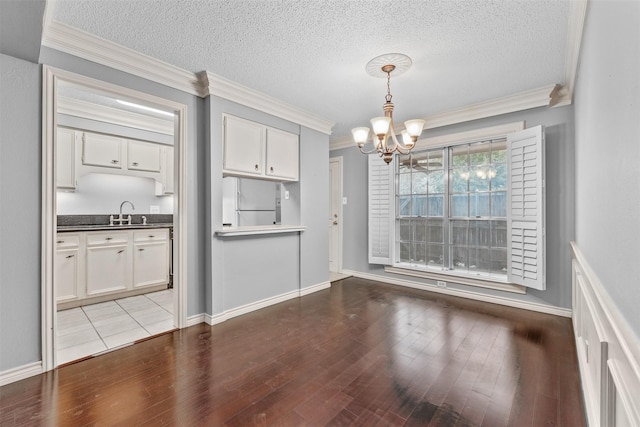 unfurnished dining area featuring a textured ceiling, hardwood / wood-style flooring, and a notable chandelier