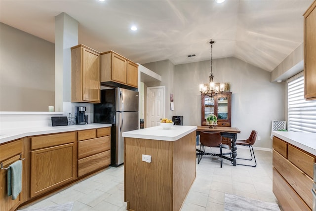 kitchen with lofted ceiling, a notable chandelier, a center island, hanging light fixtures, and stainless steel fridge