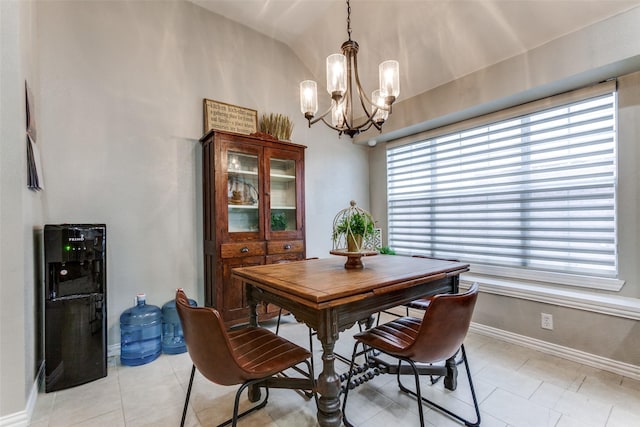 dining space with light tile patterned flooring, a chandelier, and vaulted ceiling