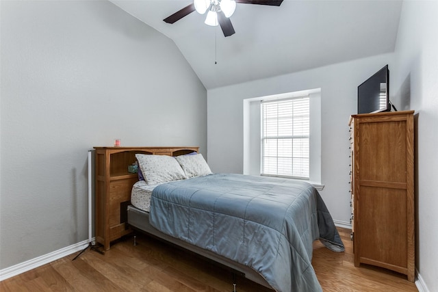 bedroom featuring ceiling fan, vaulted ceiling, and light wood-type flooring