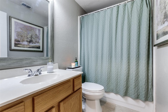 bathroom featuring tile patterned floors, vanity, and toilet