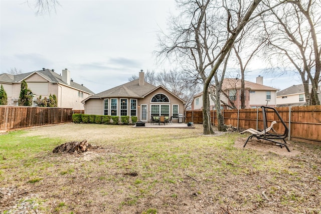 back of property with a patio area and a yard