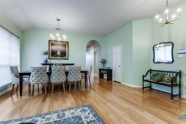 dining area with plenty of natural light, a chandelier, and light hardwood / wood-style floors