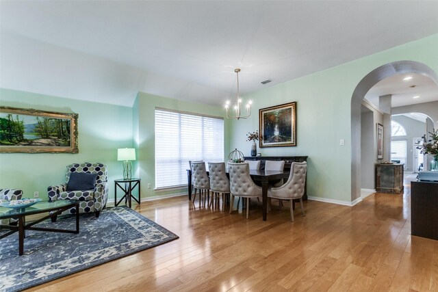 dining space featuring a chandelier and light hardwood / wood-style flooring