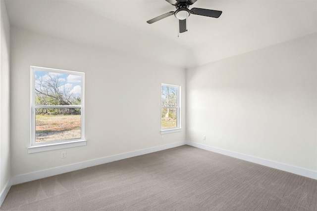 carpeted spare room featuring ceiling fan