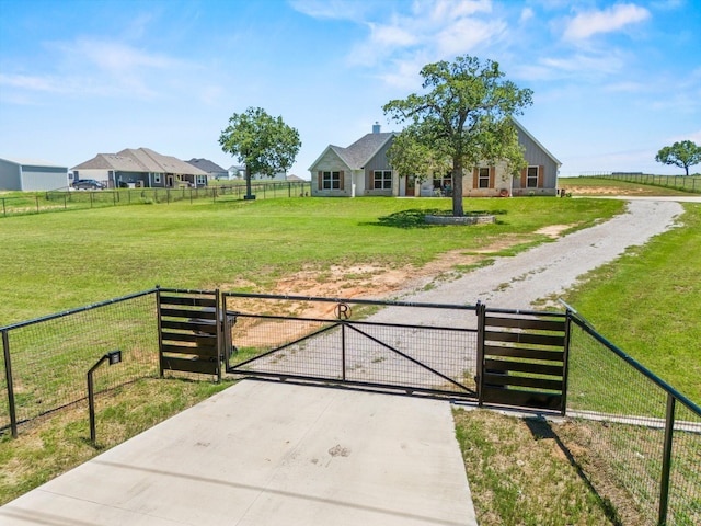 view of gate with a lawn