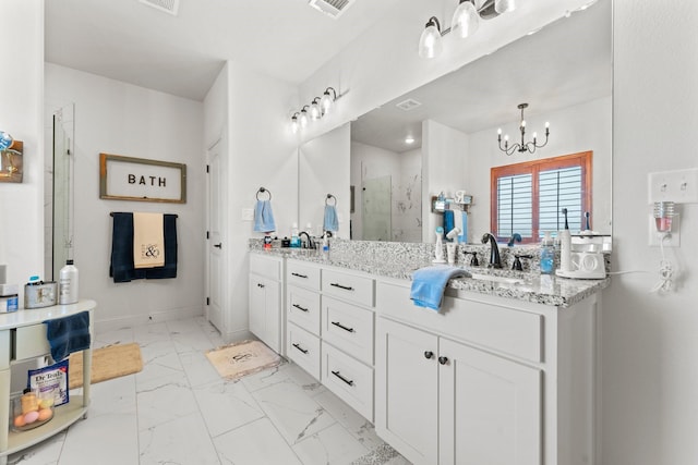 bathroom with an enclosed shower, vanity, and a chandelier