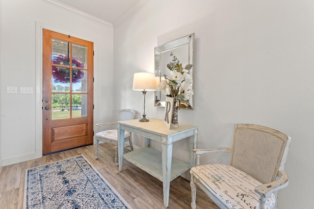 entryway featuring light hardwood / wood-style flooring and ornamental molding