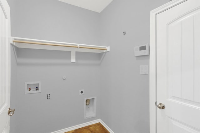 clothes washing area featuring electric dryer hookup, washer hookup, baseboards, gas dryer hookup, and laundry area