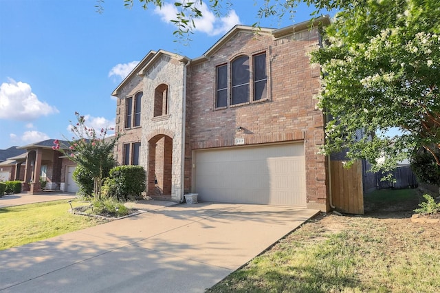 view of front of home featuring brick siding, an attached garage, a front lawn, stone siding, and driveway