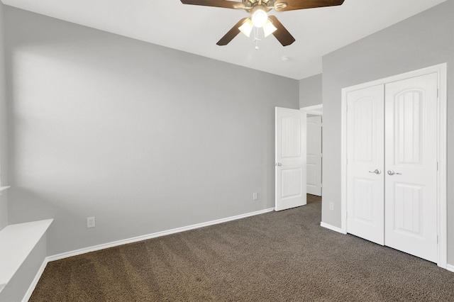 unfurnished bedroom with a closet, dark carpet, a ceiling fan, and baseboards