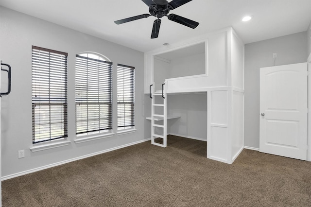 unfurnished bedroom featuring a ceiling fan, recessed lighting, baseboards, and dark colored carpet