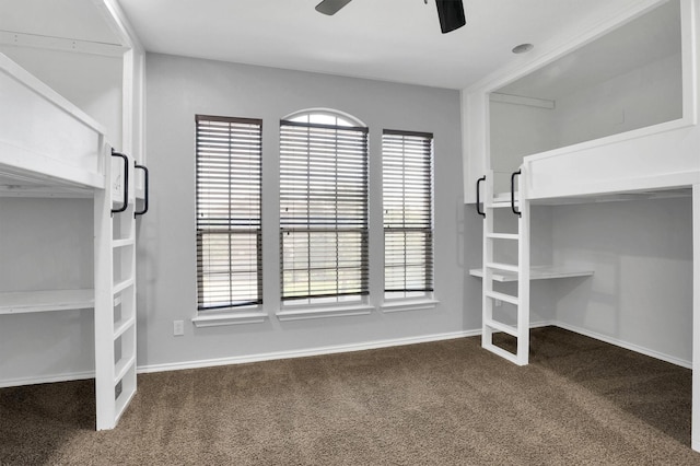 unfurnished bedroom with carpet flooring, a ceiling fan, and baseboards