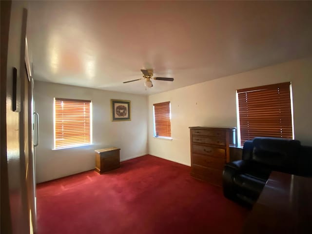 living area with ceiling fan and carpet floors