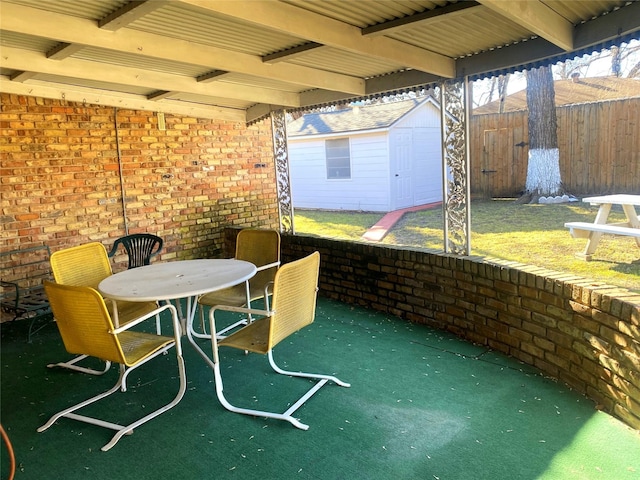 view of patio / terrace with a shed