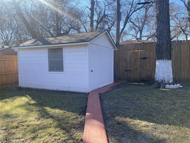 view of outbuilding with a yard