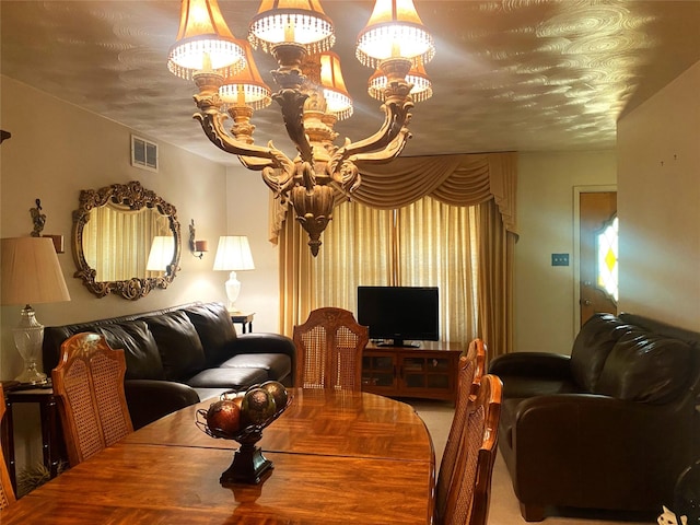 carpeted living room featuring a textured ceiling and a notable chandelier