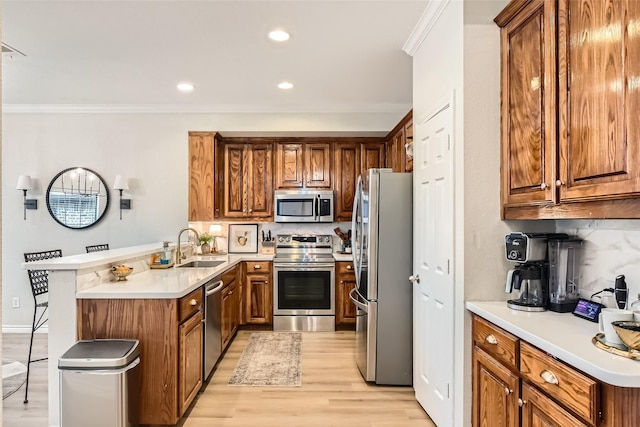 kitchen featuring sink, crown molding, stainless steel appliances, decorative backsplash, and light wood-type flooring