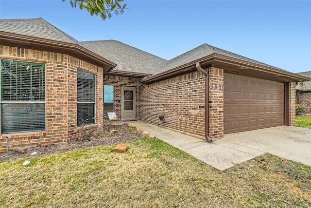 view of front of home with a garage and a front lawn