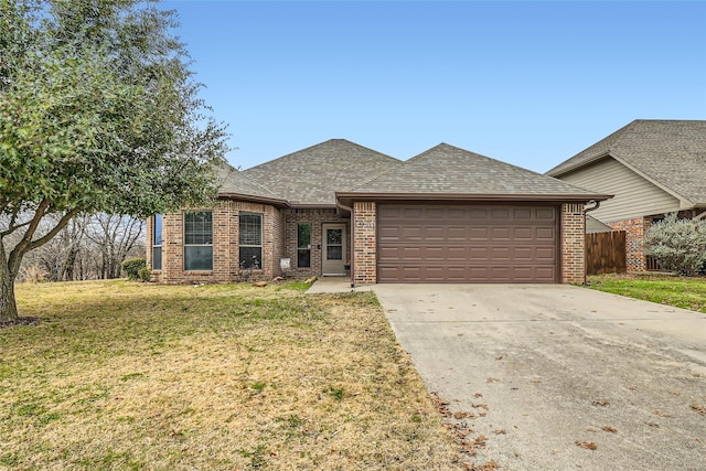 view of front of property with a garage and a front lawn