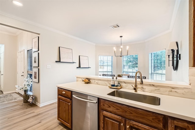 kitchen featuring sink, crown molding, decorative light fixtures, dishwasher, and light hardwood / wood-style floors