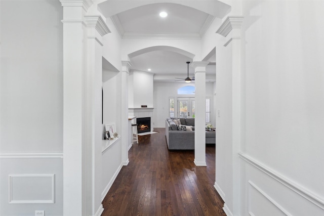 corridor with ornamental molding, dark hardwood / wood-style flooring, and ornate columns