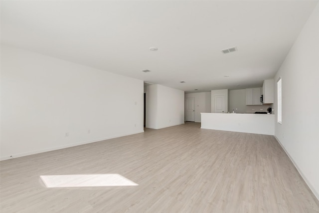 unfurnished living room featuring light wood-type flooring