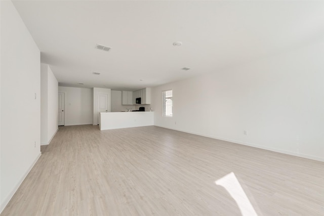 unfurnished living room featuring light hardwood / wood-style floors