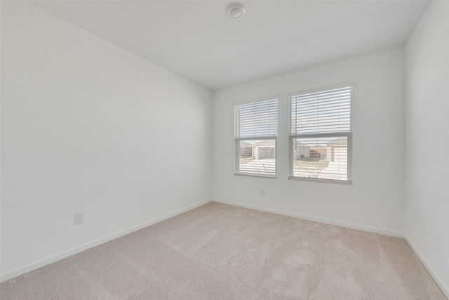 empty room with light colored carpet