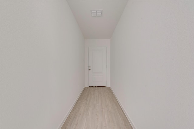 hallway with light hardwood / wood-style floors