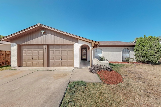 single story home with a garage and a front yard