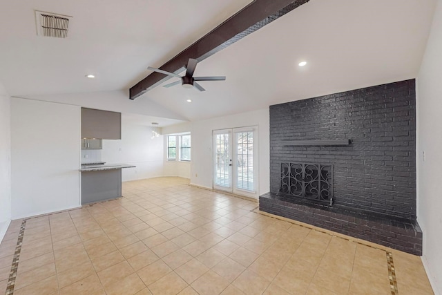 unfurnished living room with french doors, vaulted ceiling with beams, ceiling fan, light tile patterned flooring, and a brick fireplace