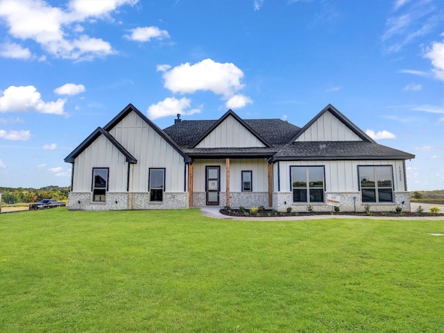 modern farmhouse style home with a front lawn