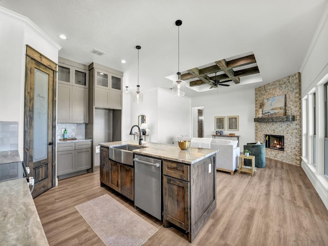 kitchen with dishwasher, sink, light stone counters, beam ceiling, and coffered ceiling