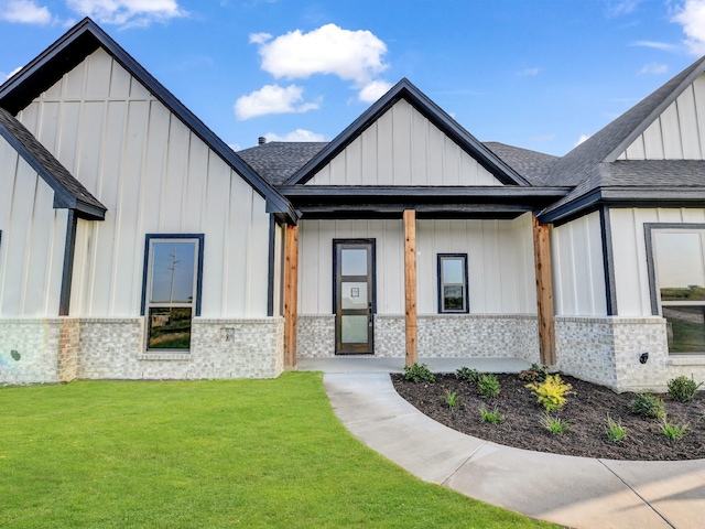 view of front of house with a front yard and a porch