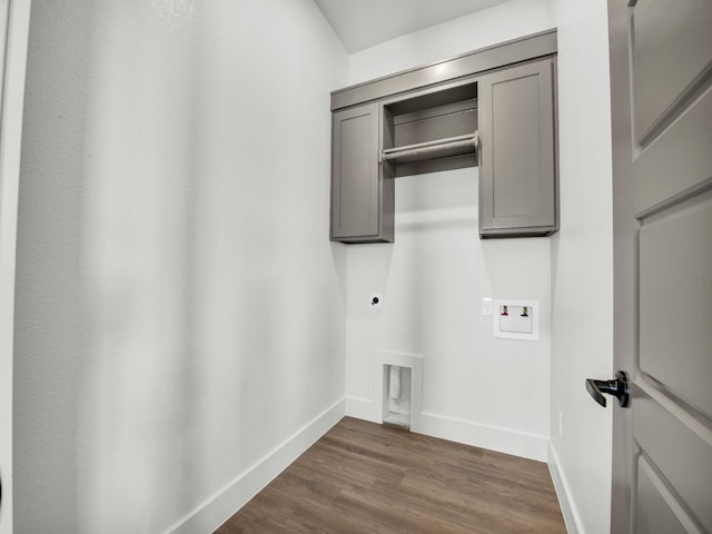 laundry room featuring cabinets, washer hookup, hookup for an electric dryer, and dark wood-type flooring